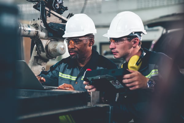 factory-workers-working-with-adept-robotic-arm-workshop